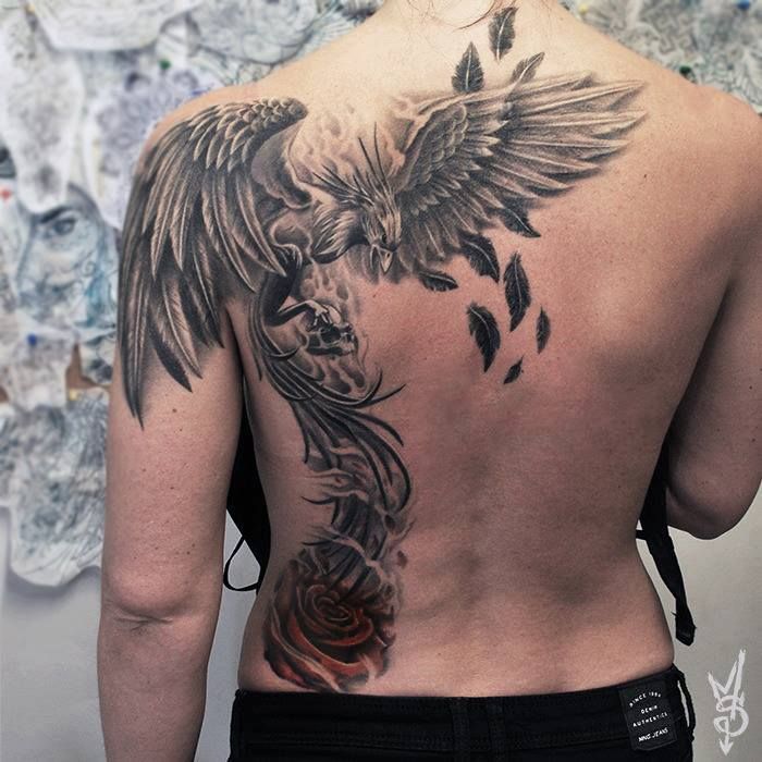 Rising phoenix and rose tattoo on guy’s back and shoulder