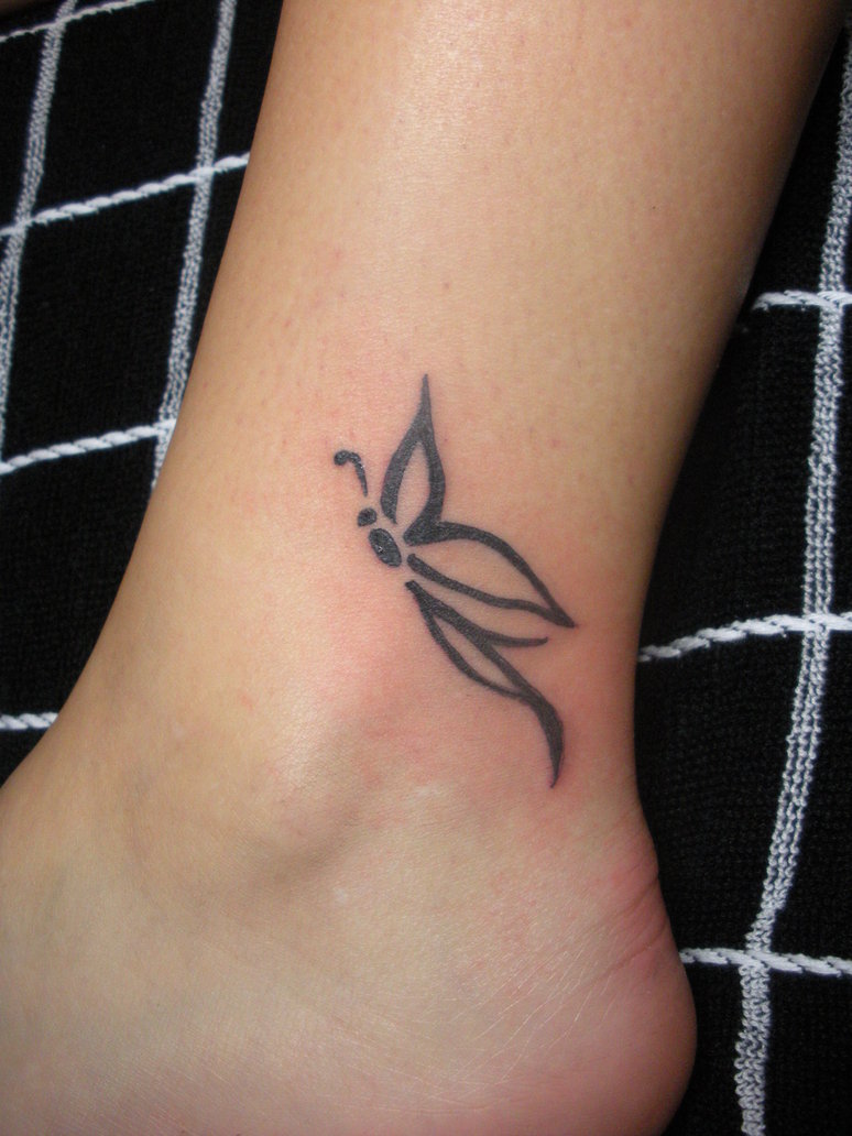 Simple black pixie butterfly tattoo on foot