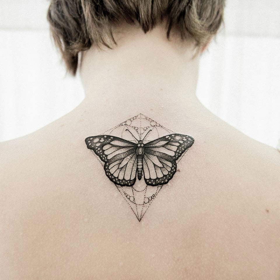 Simple Celtic butterfly tattoo on middle upper back