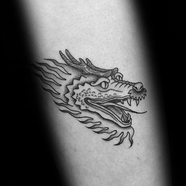 Simple dragon face tattoo on arm