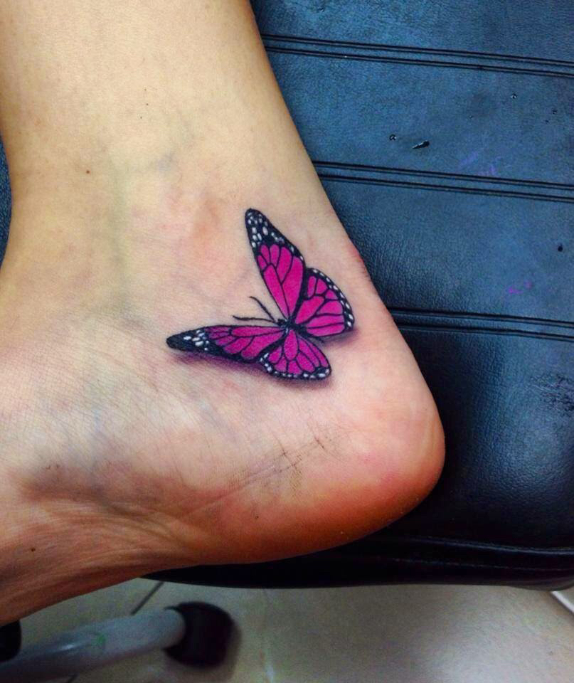 Small purple butterfly tattoo on heel