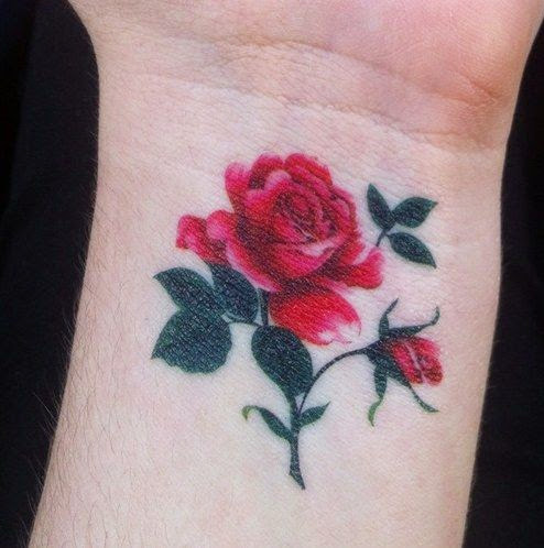 Small red rose with leaves tattoo on inner wrist