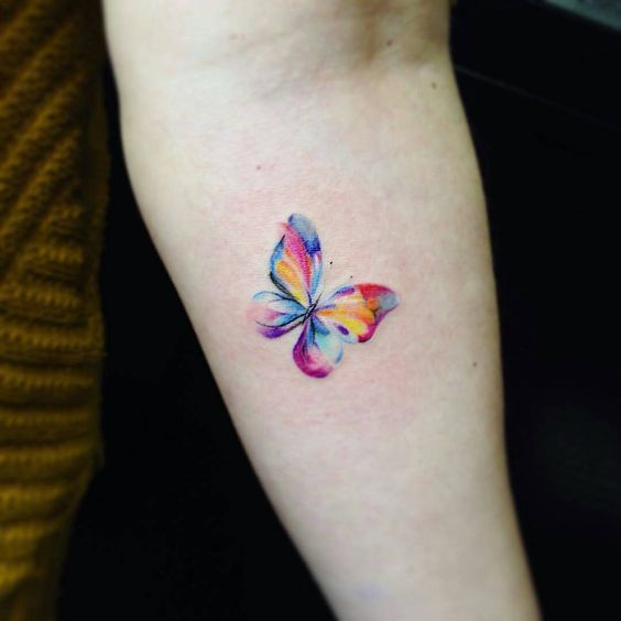 Small watercolor butterfly tattoo on inner arm