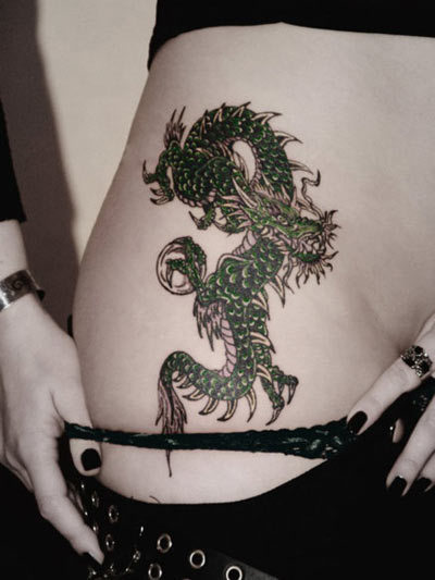 Spiked dragon tattoo on right waist