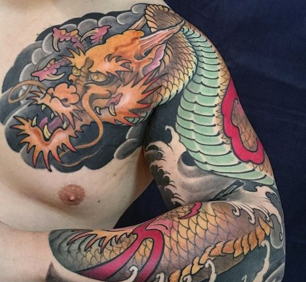 Traditional Yellow Angry dragon tattoo on left arm and shoulder