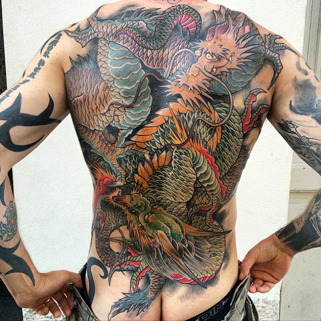 Traditional colorful dragon tattoo on full male back