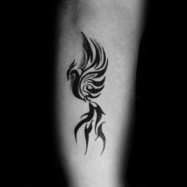 Tribal Phoenix Tattoos on man's outer forearm