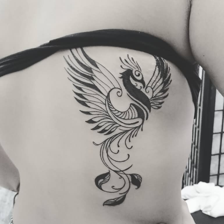 Tribal design phoenix tattoo on girl side back