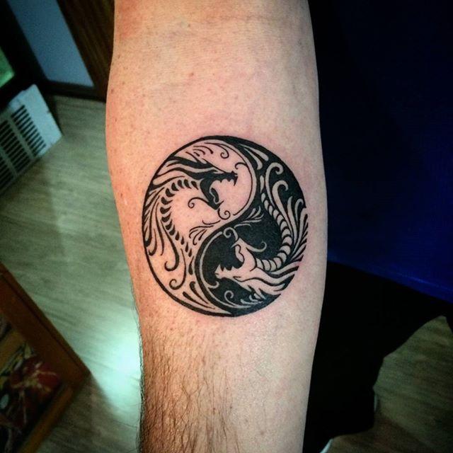 Unique yin yang dragon tattoo design on inner mid arm