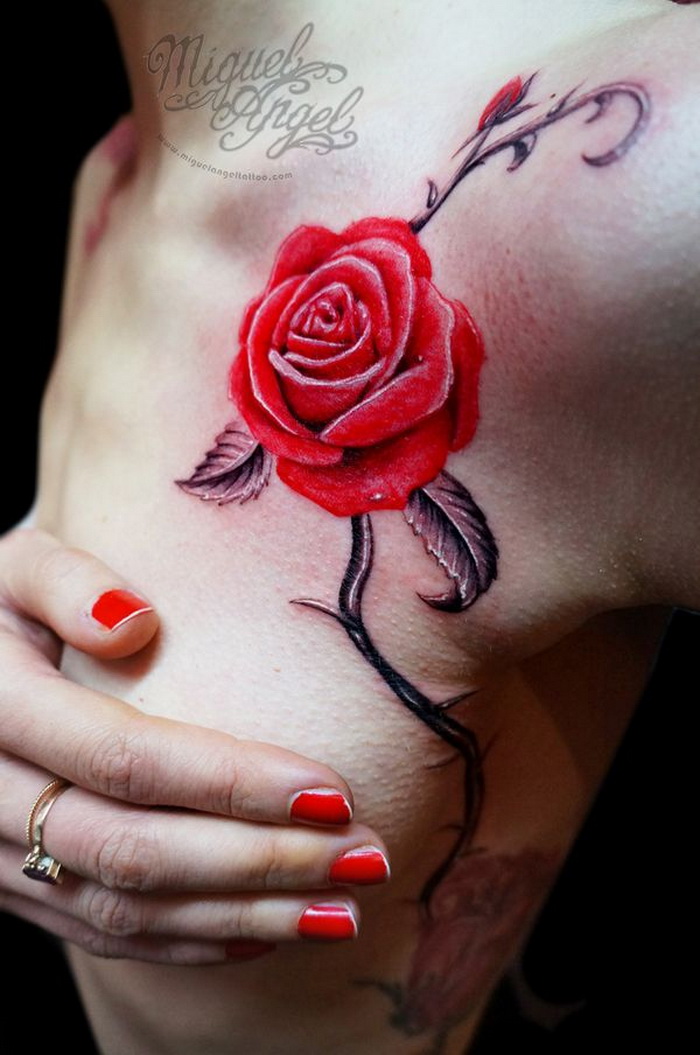 Women shoulder red rose tattoo with grey leaves & stem