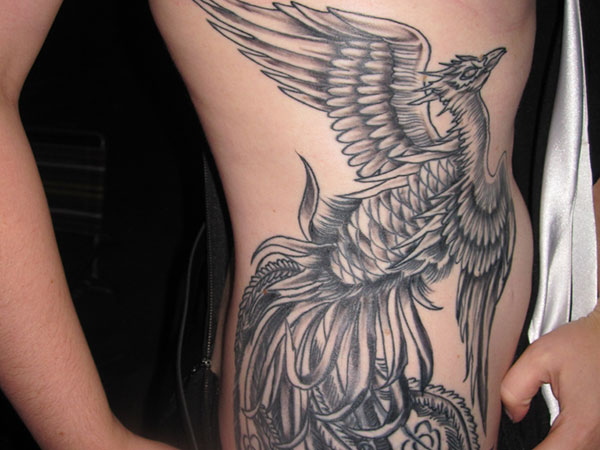 Wonderful big grey phoenix tattoo on girl side