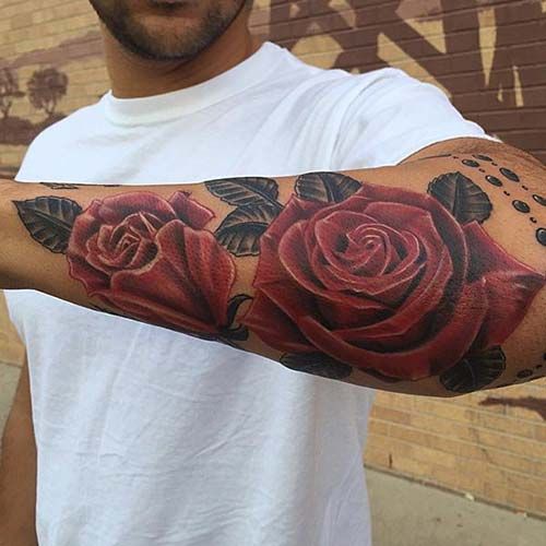 Wonderful red roses with dark grey leaves outer forearm tattoo for men