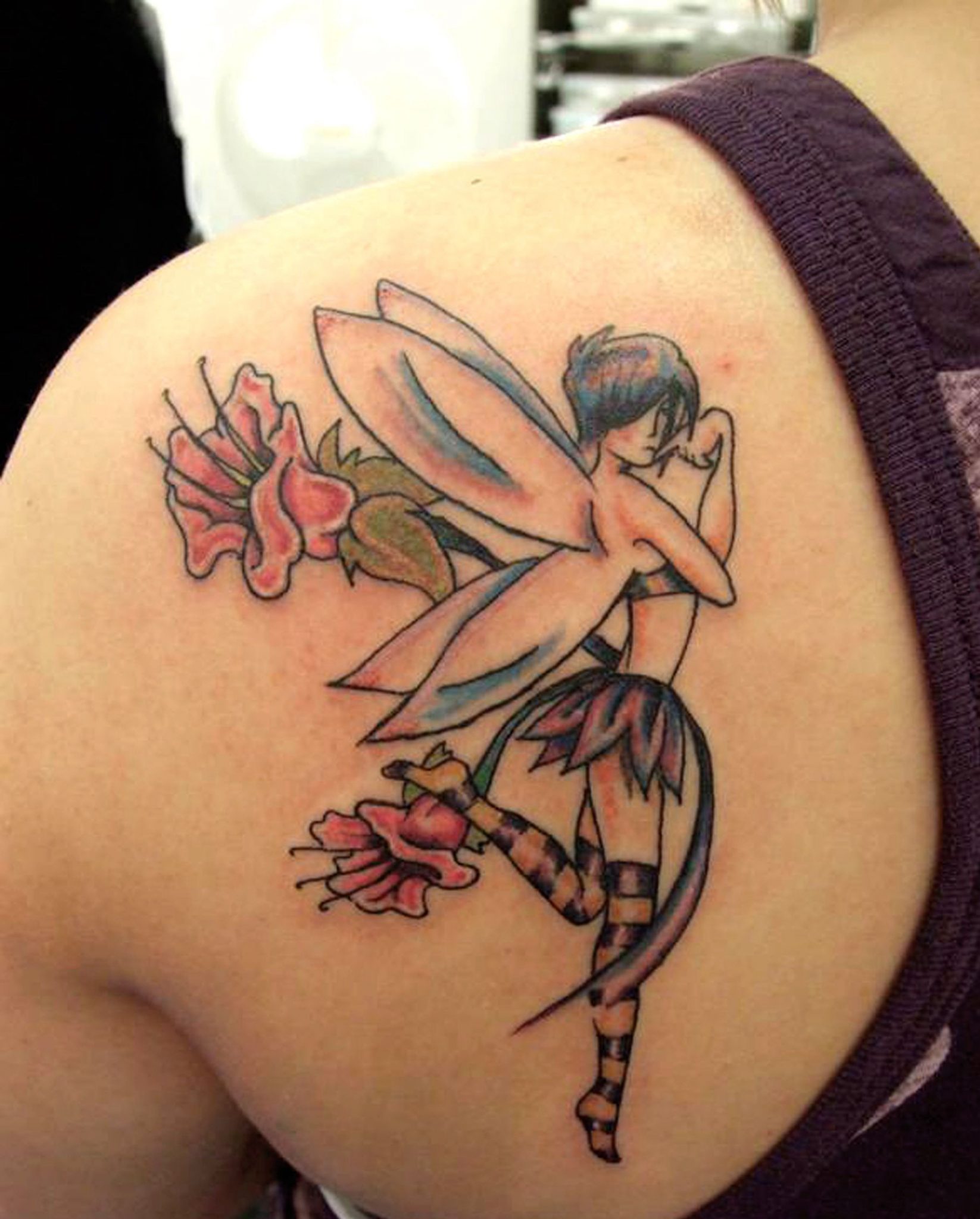 colorful butterfly angel tattoo on back left shoulder
