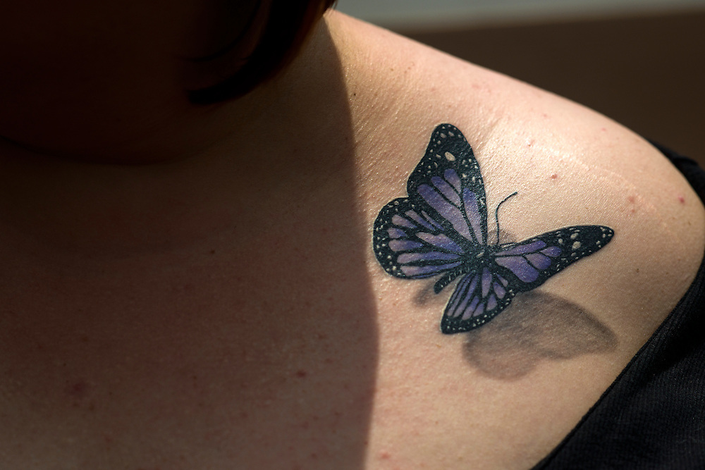 Purple 3D butterfly tattoo on girls front shoulder