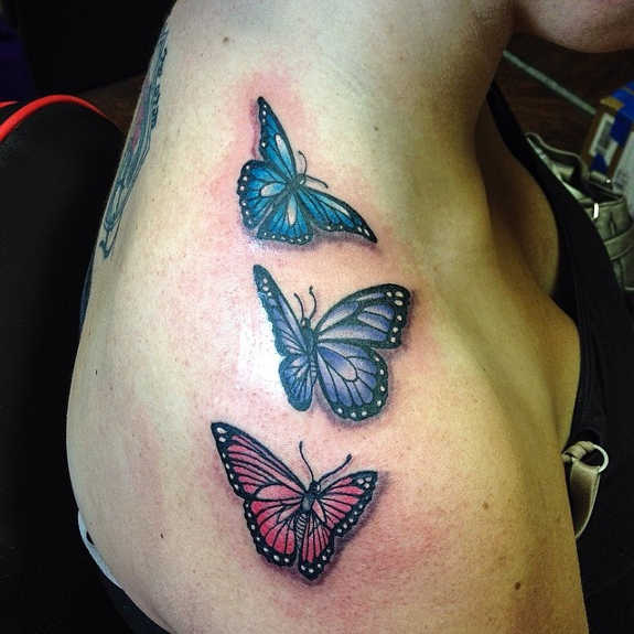 Red and blue three Butterflies tattoo on shoulder