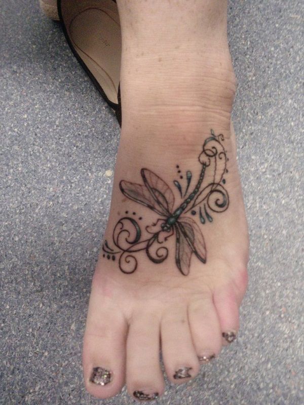 Beautifully designed feminine dragonfly tattoo on foot
