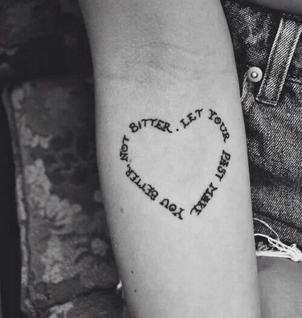 Black Ink message in heart shape tattoo for girl’s forearm