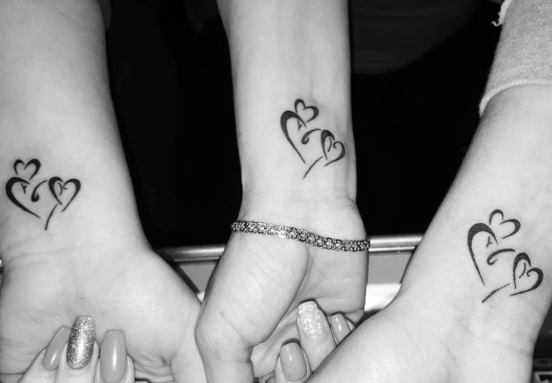 Black Matching three hearts tattoo on inner wrist for women