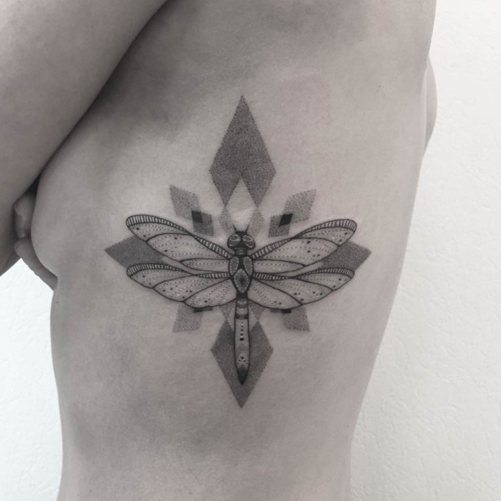 Black and grey shaded geometric dragonfly tattoo on left body for women