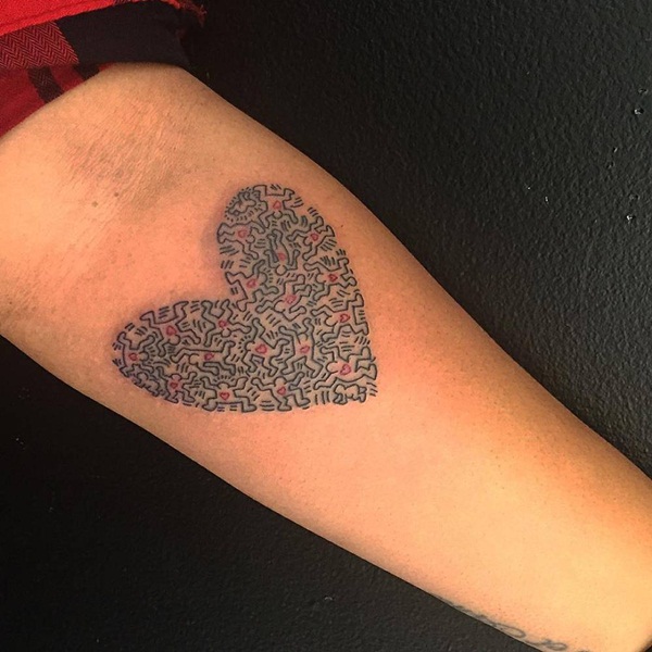 Black and red designed heart tattoo on forearm