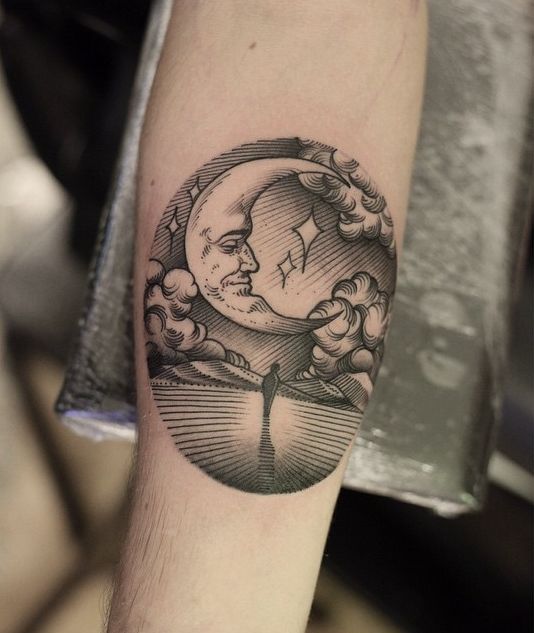 Black and white shaded half moon with picture tattoo on arm