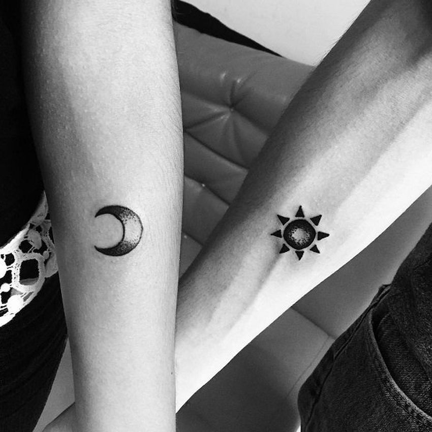 Black and white shaded sun and moon tattoo on inner arms