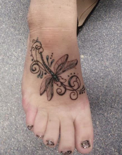 Black dragonfly tattoo design on foot for women