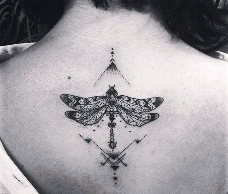 Black geometric dragonfly tattoo on girl upper back