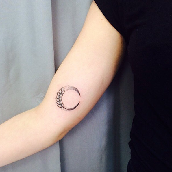 Black half moon with leaves tattoo on inner arm for women