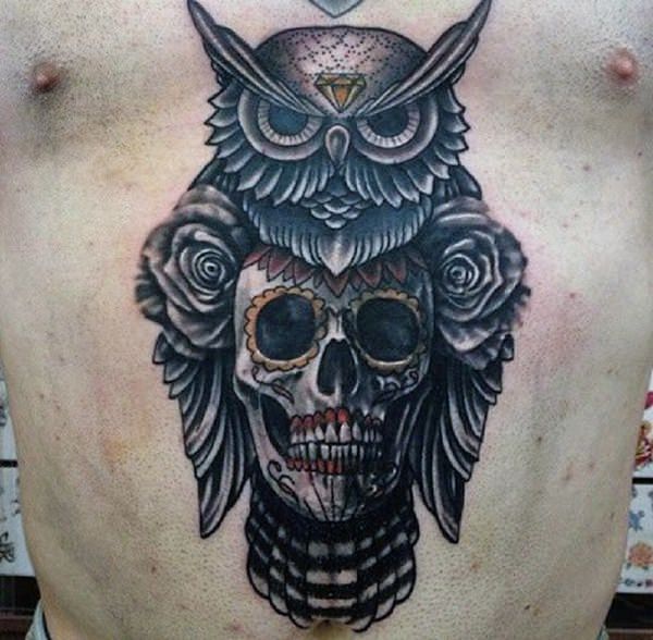 Black ink dark owl and skull tattoo on man chest