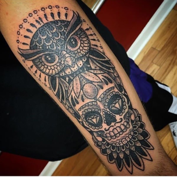 Black ink owl and sugar skull tattoo on sleeve for men.