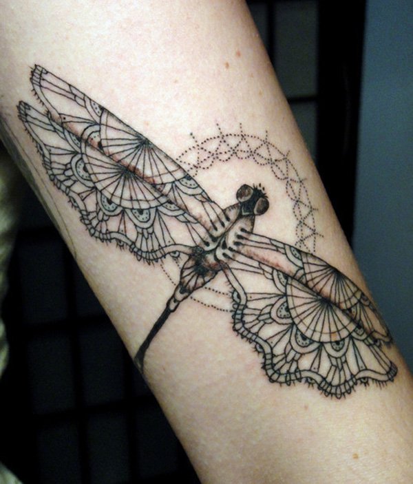 Black outlined designed wing dragonfly tattoo on inner arm for women