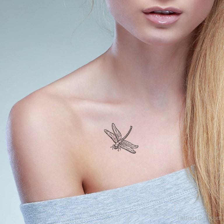 Black outlined dragonfly tattoo on front shoulder for women