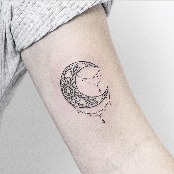 Black outlined floral half moon tattoo design on arm for women