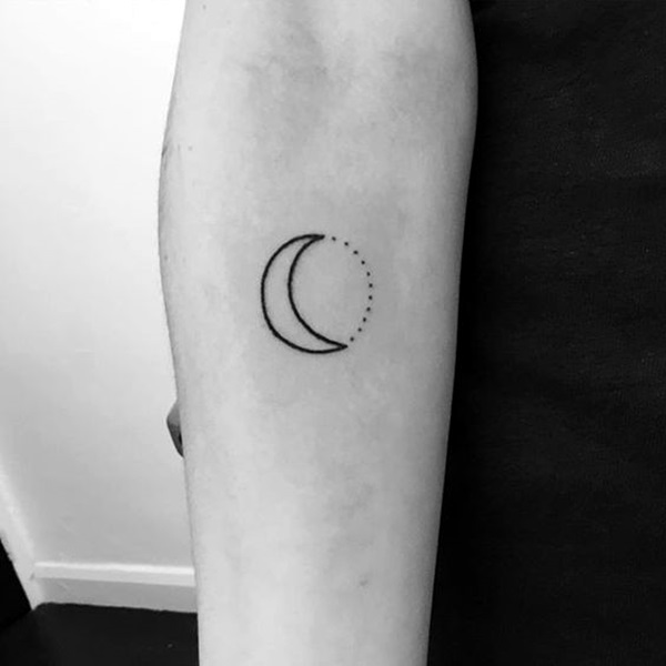 Black outlined half moon and dotted full moon tattoo on mid inner arm