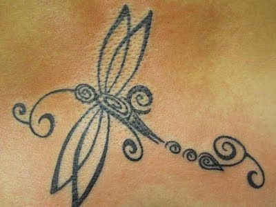 Black outlined tribal dragonfly tattoo on body