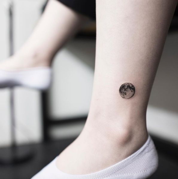 Black shaded tiny 3d moon tattoo on left foot