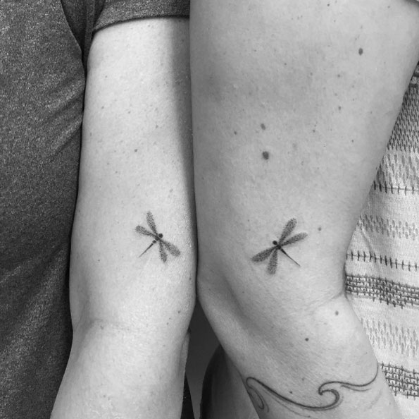 Black small dragonfly tattoo on sleeve for couple