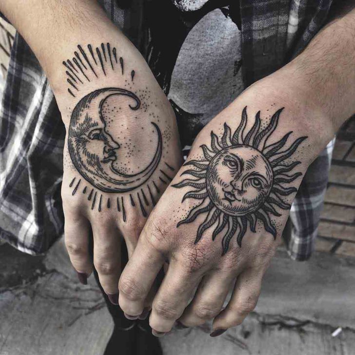 Black sun and moon tattoo on upper hands