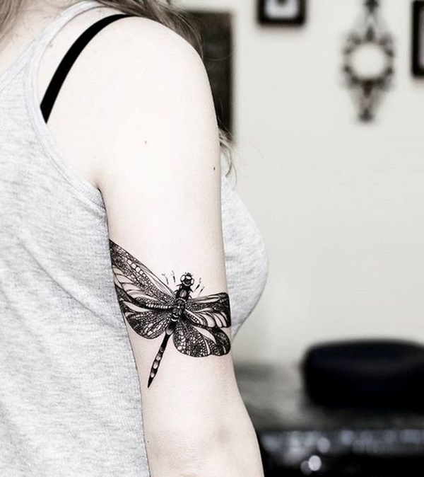 Black tribal dragonfly tattoo design on upper sleeve