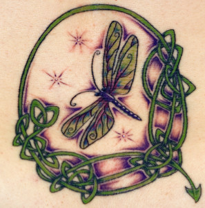Colored dragonfly with flowers tattoo design