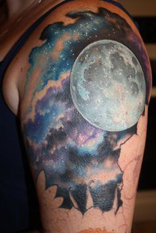 Colored full moon with galaxy tattoo on upper half sleeve for men