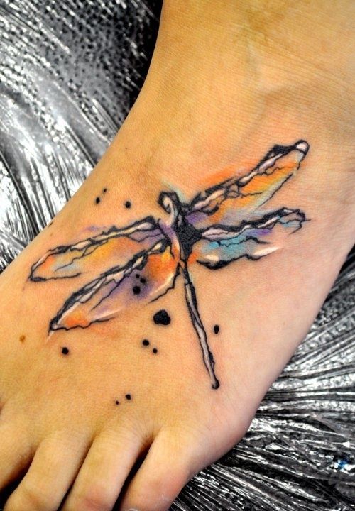 Colored watercolor dragonfly tattoo on foot