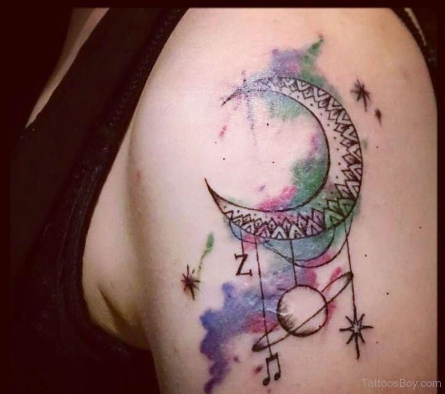 Colorful black outlined dream catcher half moon tattoo on upper arm for women