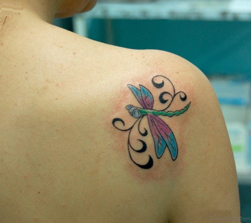 Colorful dragonfly tattoo on girl back shoulder