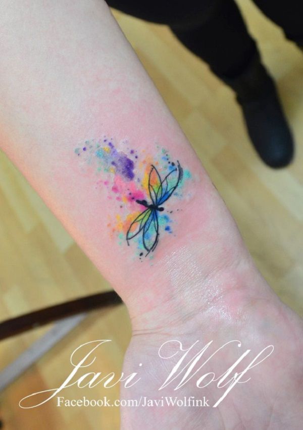 Colorful watercolor dragonfly tattoo on inner arm for women by Javi Wolf