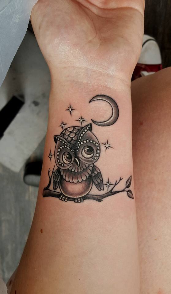 Cute baby owl with moon tattoo on wrist