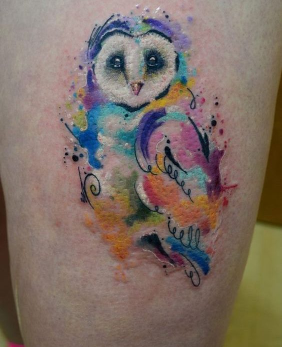 Feminine watercolor barn owl tattoo on thigh