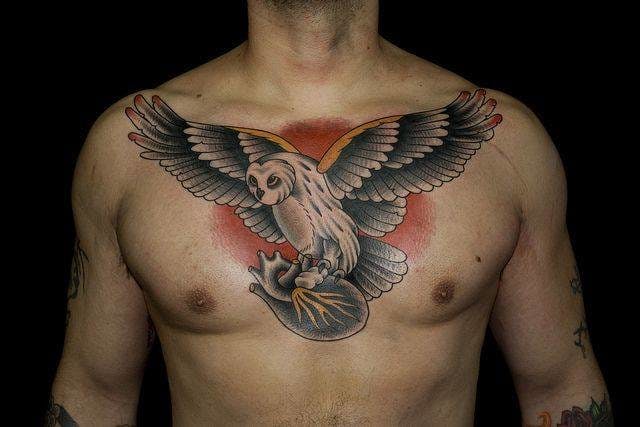 Full chest flying barn owl with anatomical heart tattoo for men