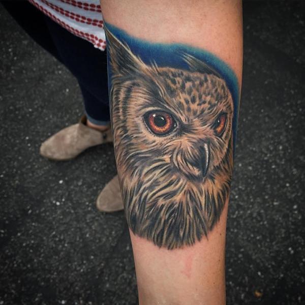 Gorgeous realistic owl head tattoo on forearm